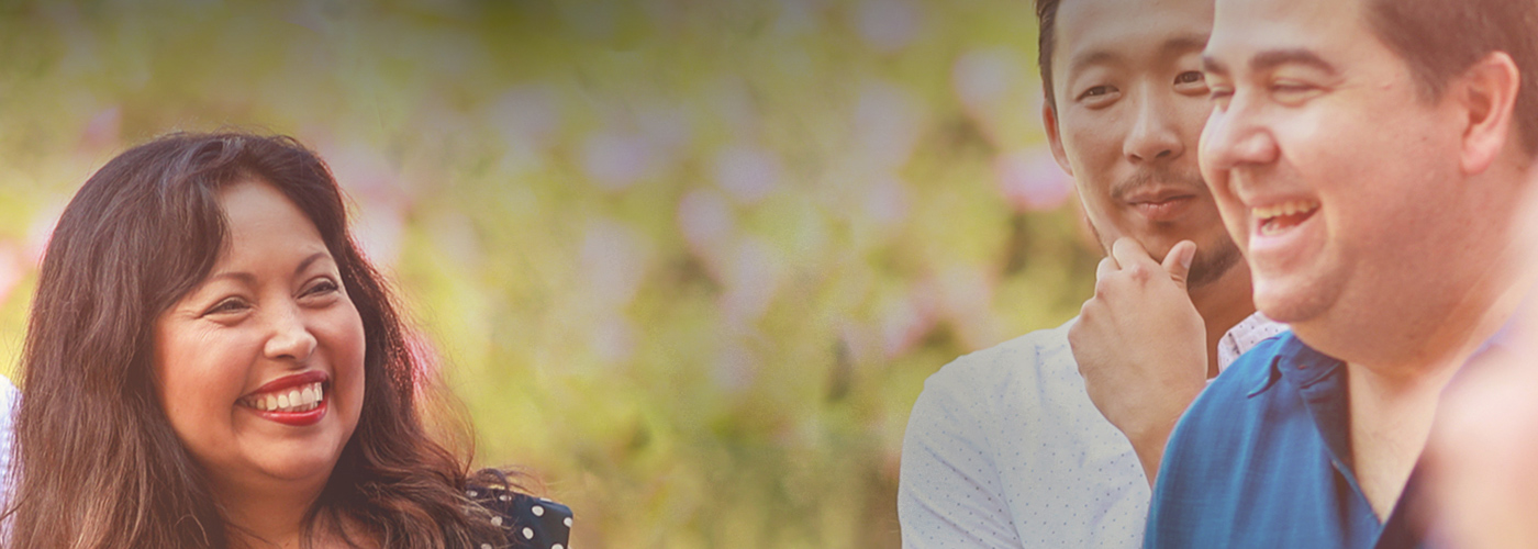 A group of SCE employees talking and laughing at an event