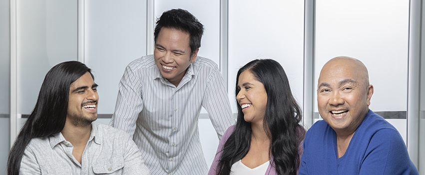 A group of people sitting and collaborating in a classroom type setting