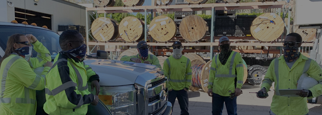 Image of several workers huddling in worksite