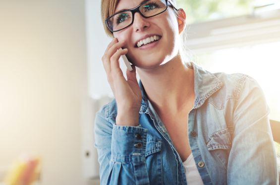 A woman talking on the phone and smiling
