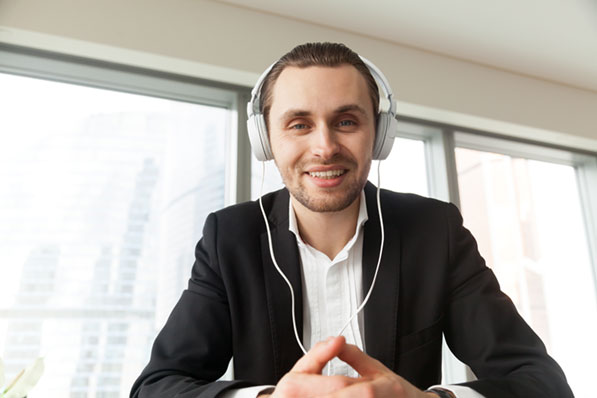A man looking at the camera with headphones