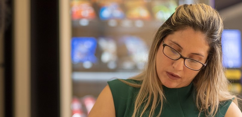 2 women working together looking down at their work