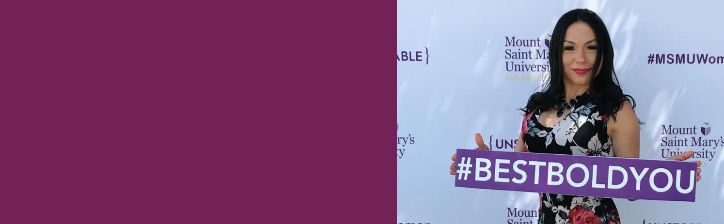 A young woman smiling holding a #bestboldyou sign