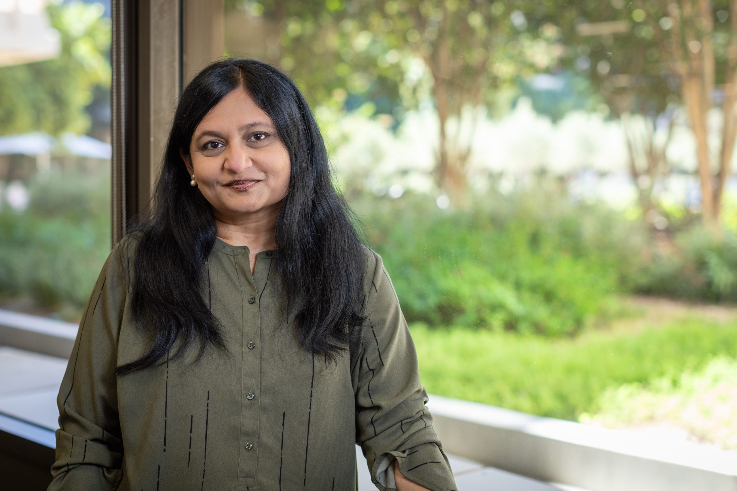 woman in an office building smiling at the camera