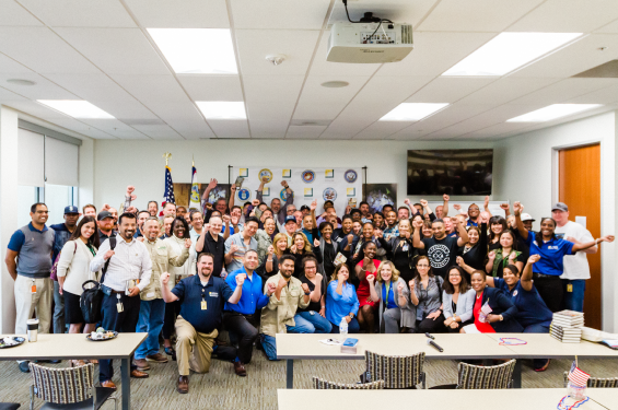 A group of veteran employees smiling at the camera