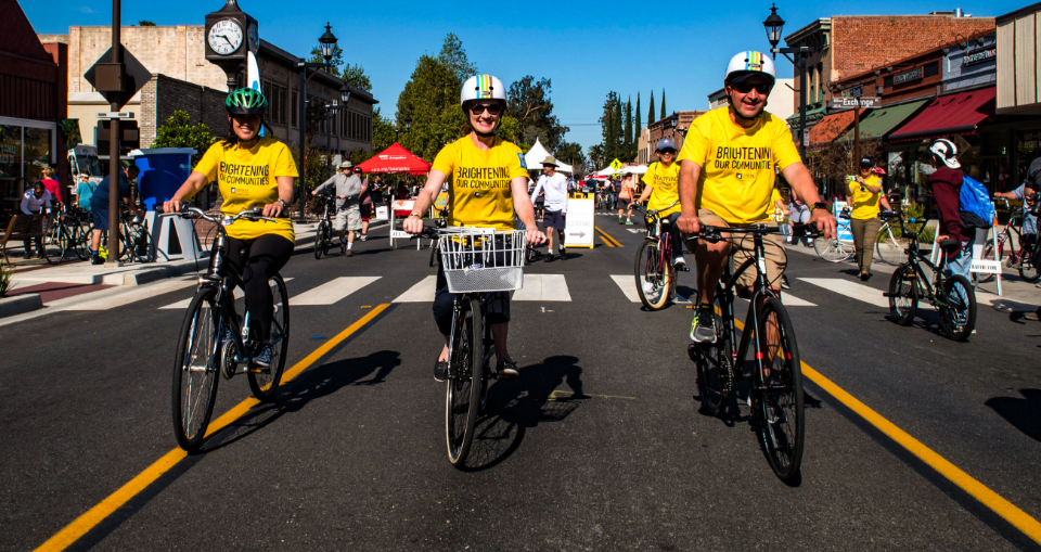 Group of team members cyclling in a community event